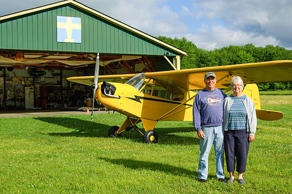 couple with airplane and barn quilt